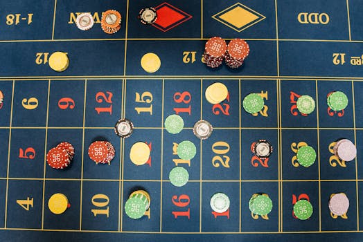 Aerial view of a roulette table with colorful poker chips showing a vibrant gambling scene.