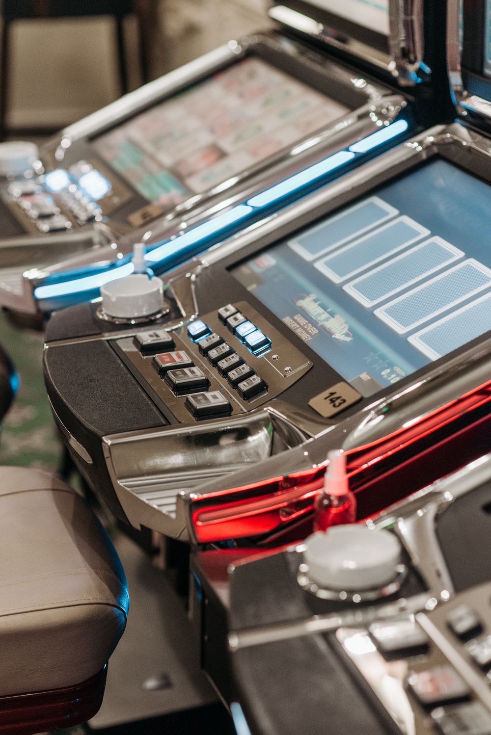 Close-up of illuminated slot machines showcasing vibrant screens and controls