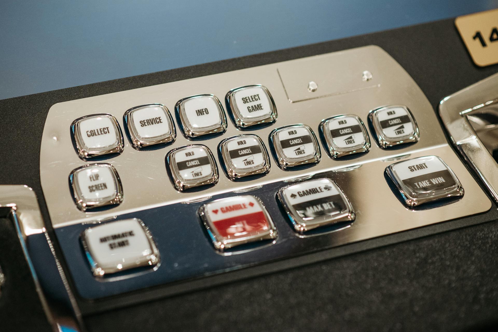 Detailed view of a casino slot machine's control panel displaying various command buttons.