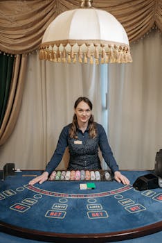 Female casino dealer standing behind a poker table in an elegant gambling hall.