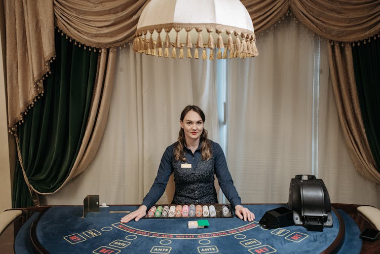 A Woman Card Dealer Posing And Smiling