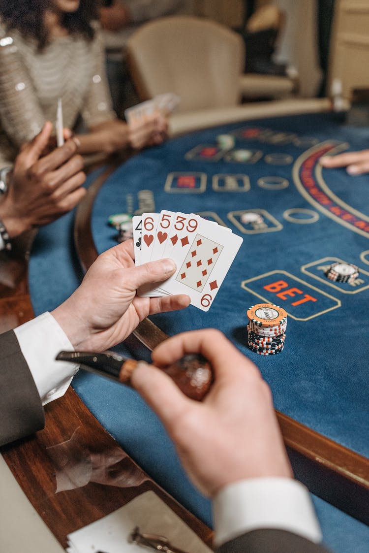 A Gambler Holding Playing Cards