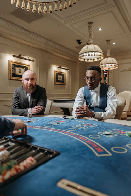 Players Sitting Around the Poker Table