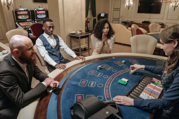 Gamblers Sitting Around A Gaming Table