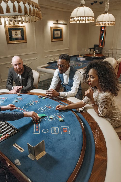 Free People Sitting on Poker Table in the Casino Stock Photo