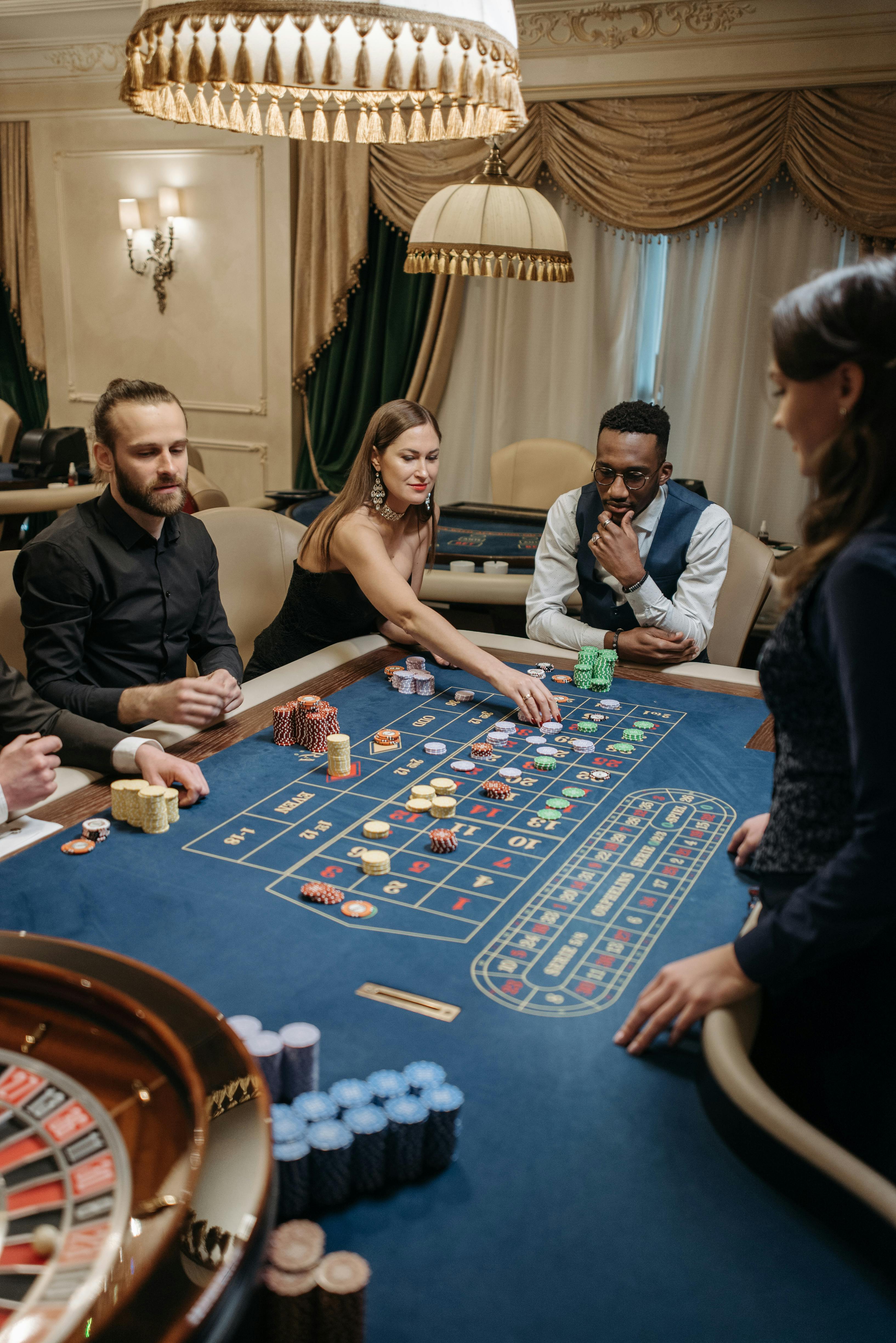 people sitting around table playing poker