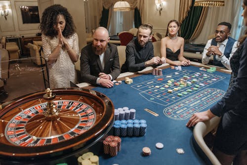 Players Looking at a Roulette