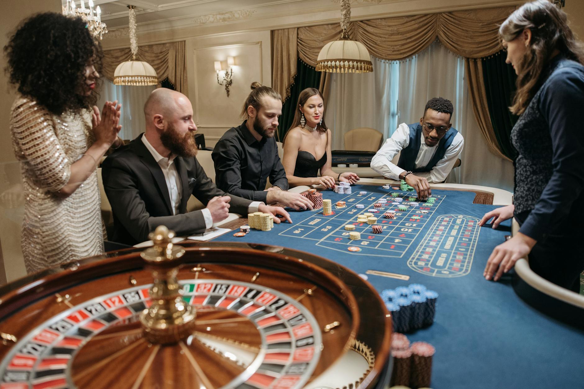 Group of People Gambling at a Roulette