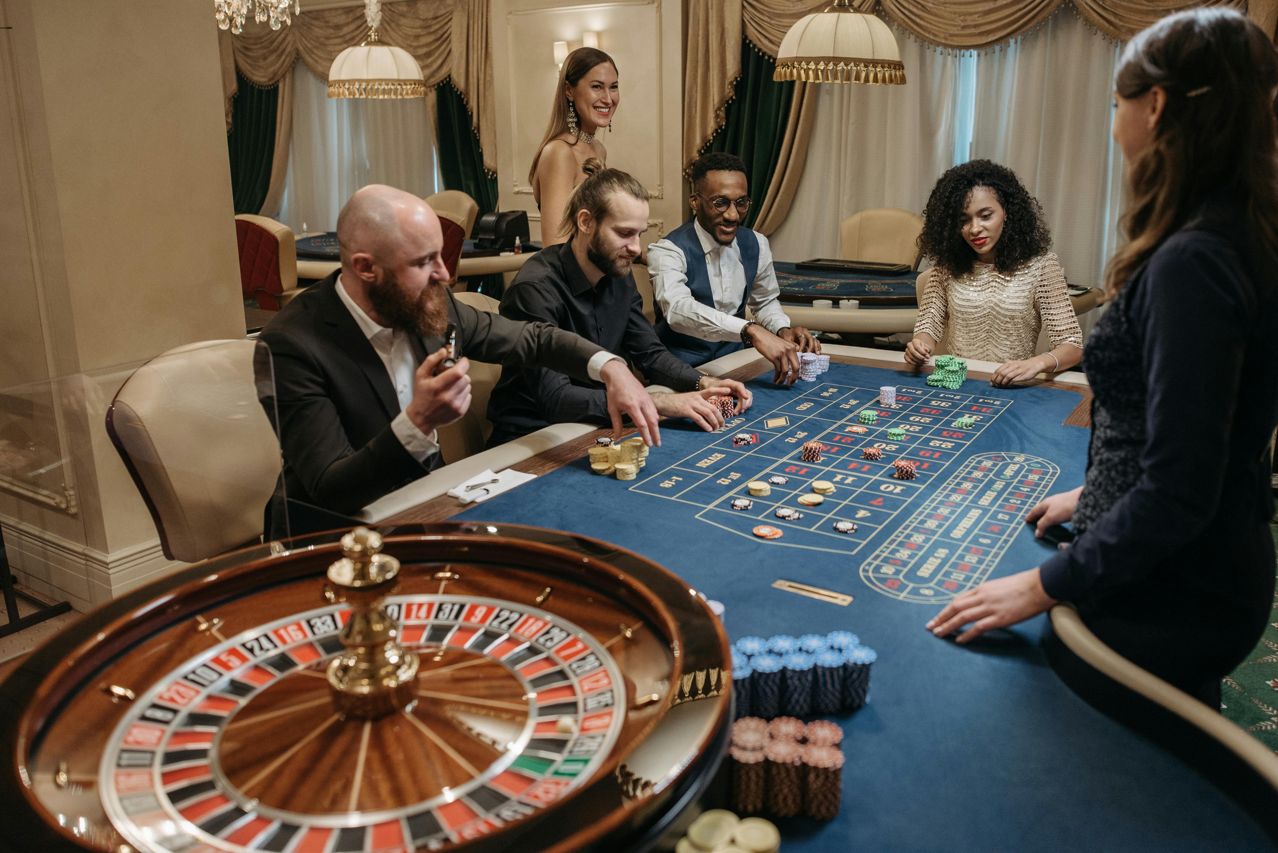 Free A Group of Gamblers Placing their Bets on Gaming Table Stock Photo