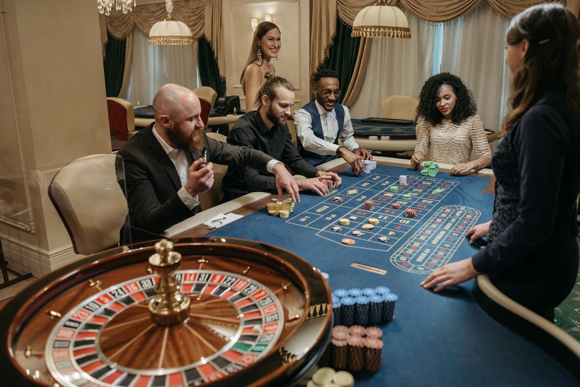 A lively casino scene with diverse people playing roulette at a gaming table.