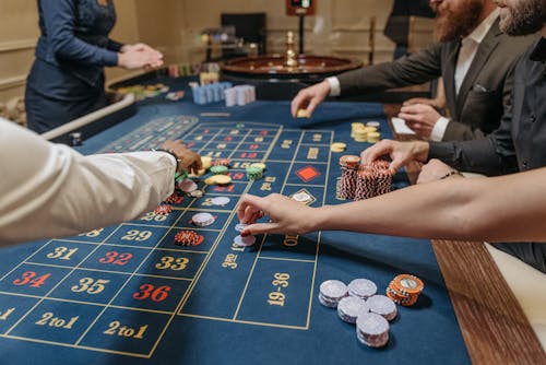 People Placing their Bets on the Gaming Table