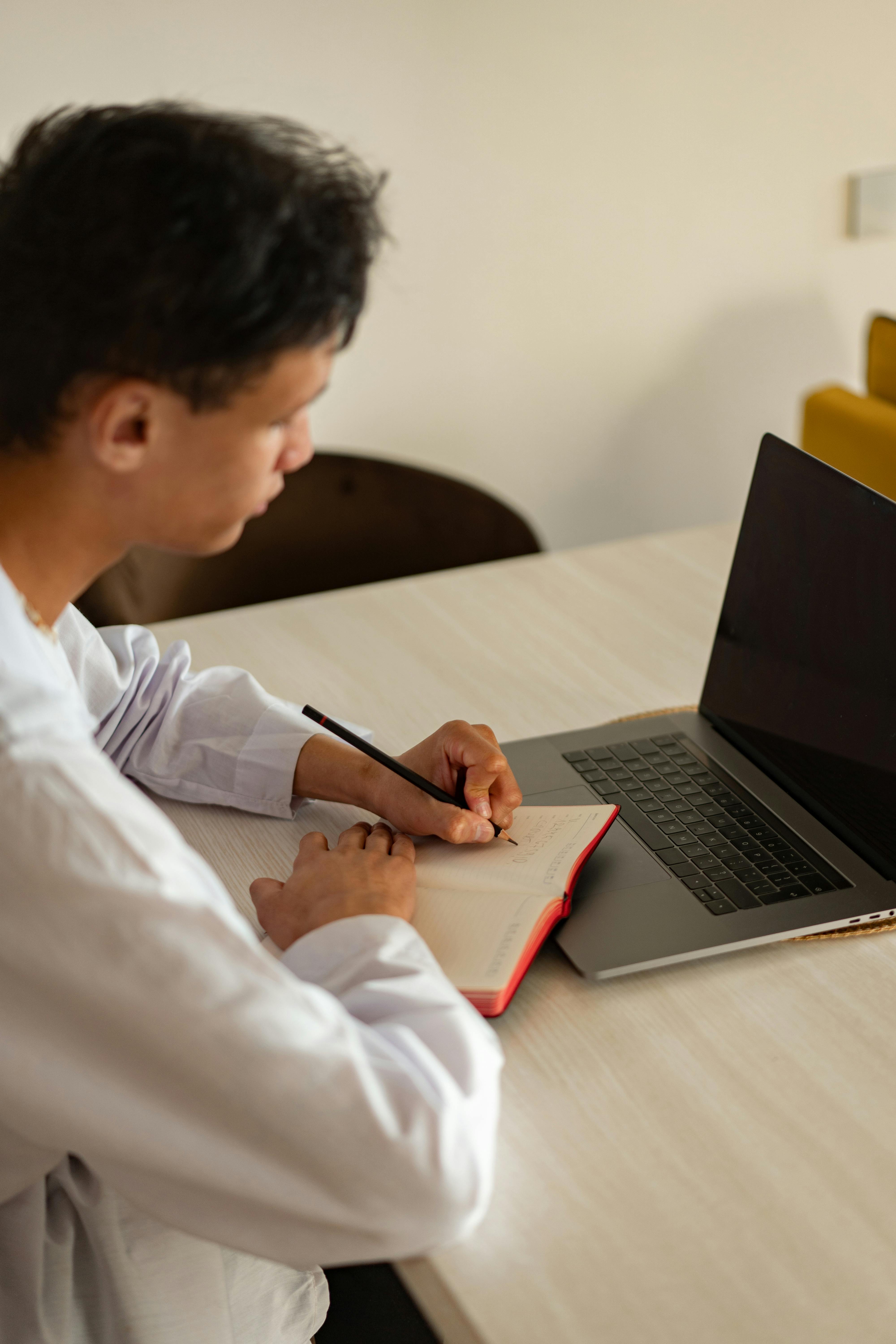 man person desk laptop