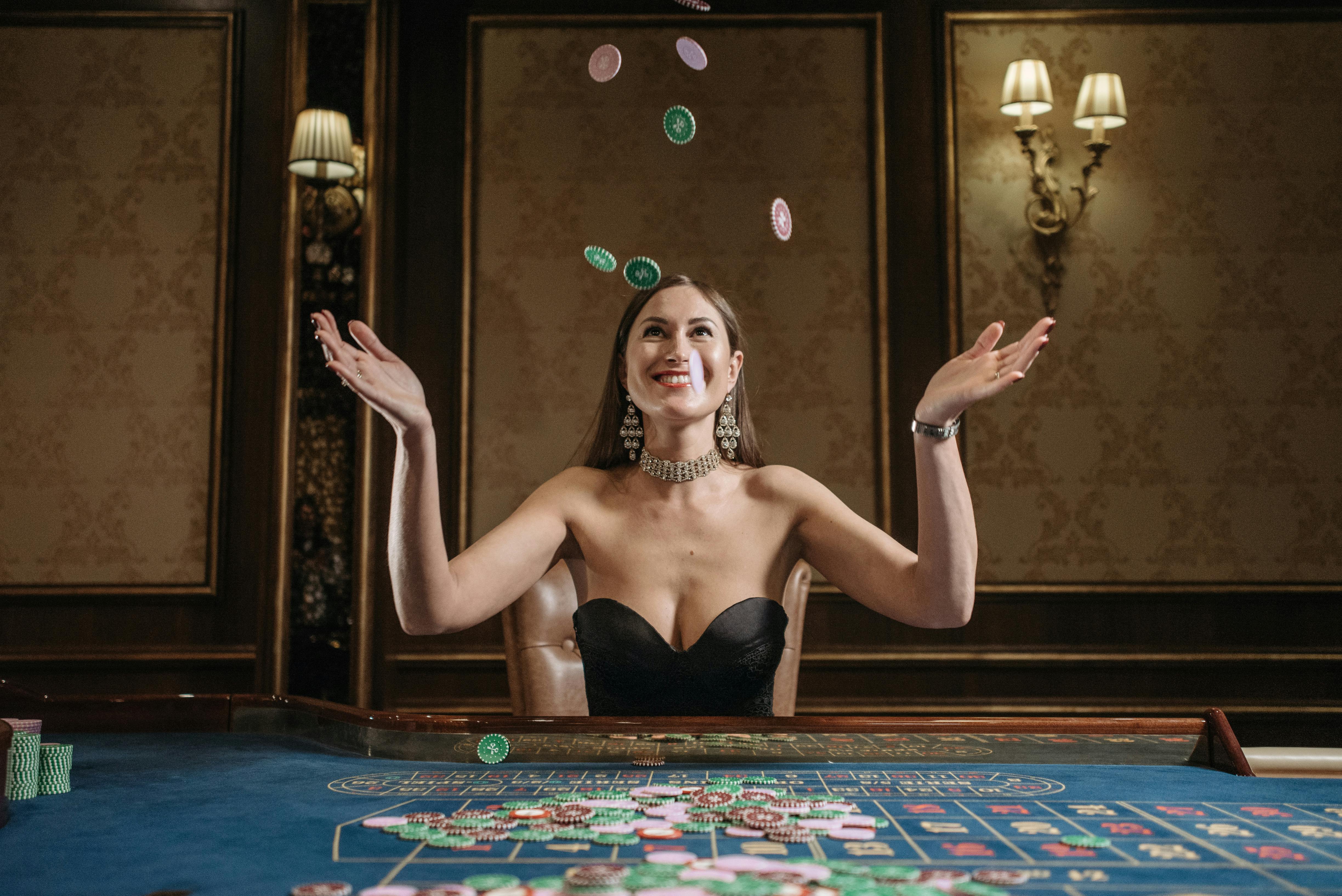 a woman in tube top tossing the casino chips in the air