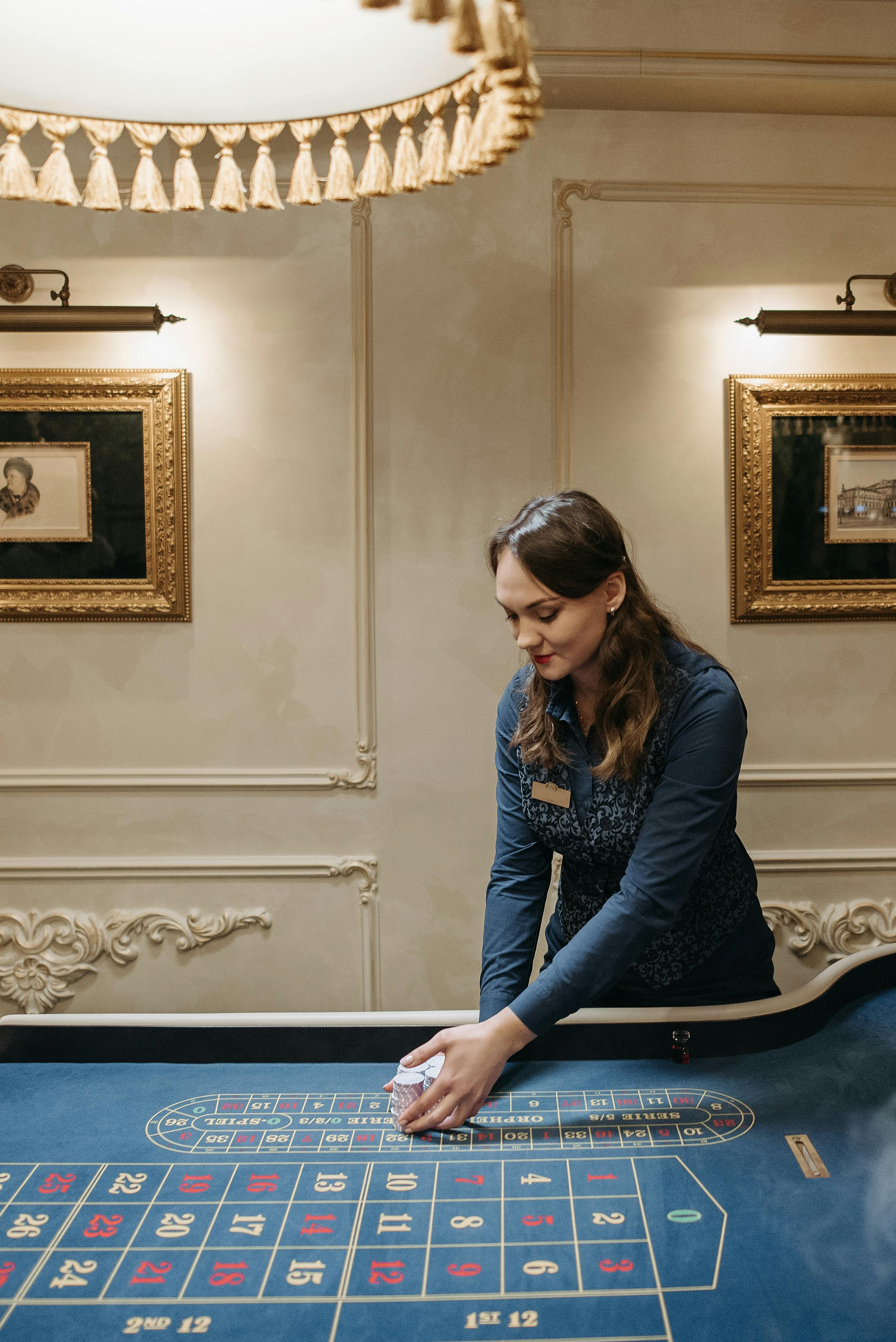 a dealer getting stacks of chips on the gaming table