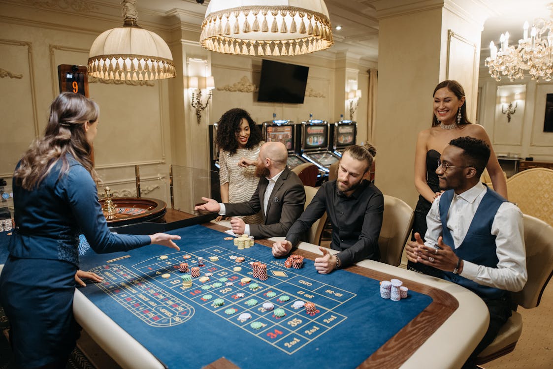 Free Group of Gamblers Playing on Roulette Table Stock Photo
