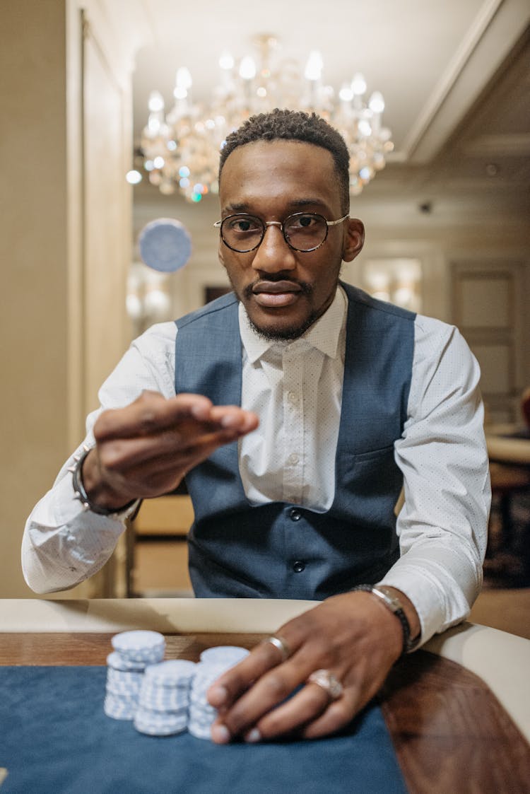 A Man Flipping A Casino Chip