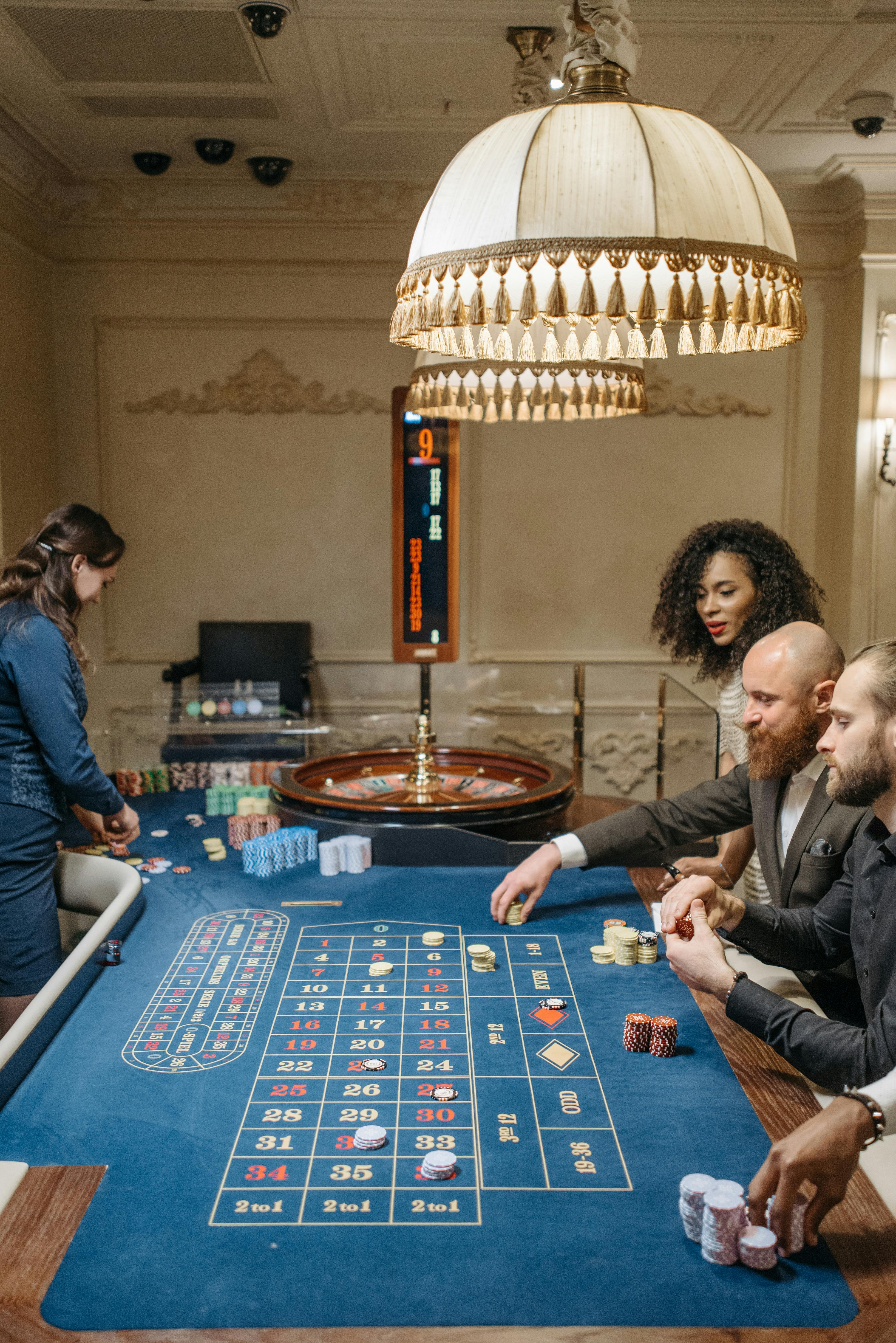 gamblers betting on roulette table