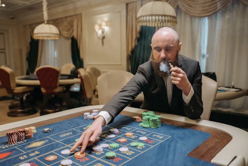 Man Playing Poker While Smoking 