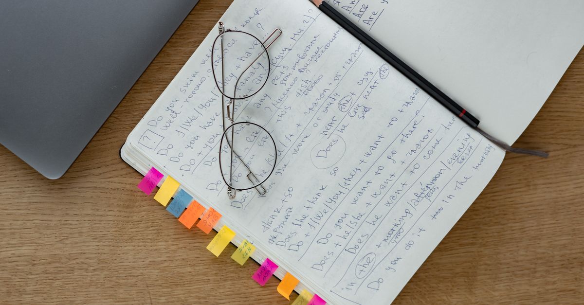a notebook and pen on a nightstand with the words