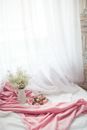 Chocolates in the Plate on the Pink Fabric Near the white Curtain