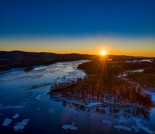 Free A breathtaking aerial view of the Mississippi River at sunset in winter, West Newton, Minnesota. Stock Photo