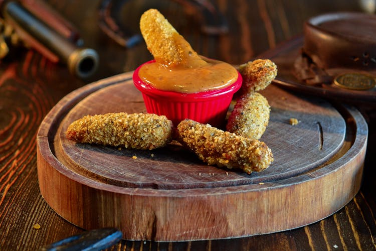 Breaded Cheese On A Wooden Chopping Board