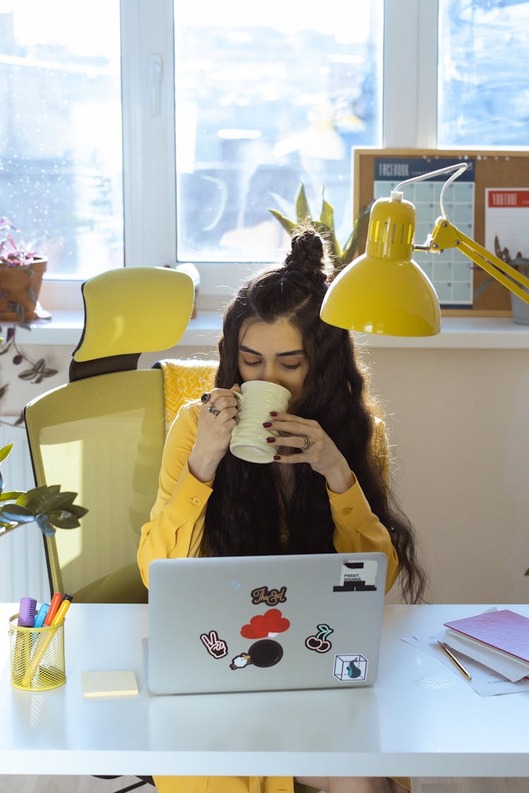 A Woman Drinking A Coffee