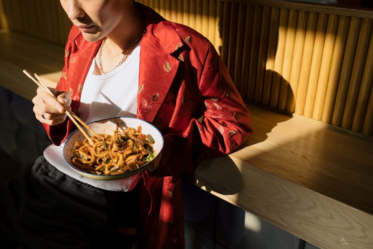 Man Eating Bowl Of Noodles