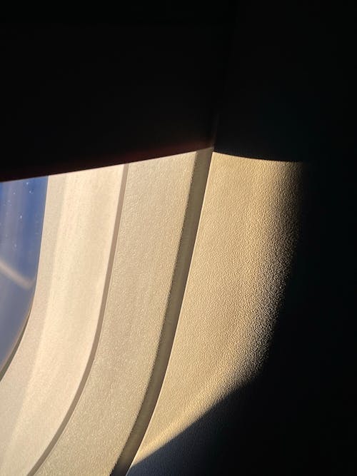 Close-up of Airplane Window in Shadow