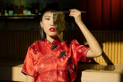 Woman Holding Chopsticks with Seaweed