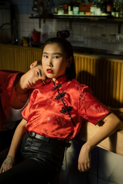 Free Couple in a trendy, intimate setting wearing modern traditional Chinese clothing. Stock Photo