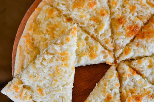 A White Pizza on a Wooden Surface