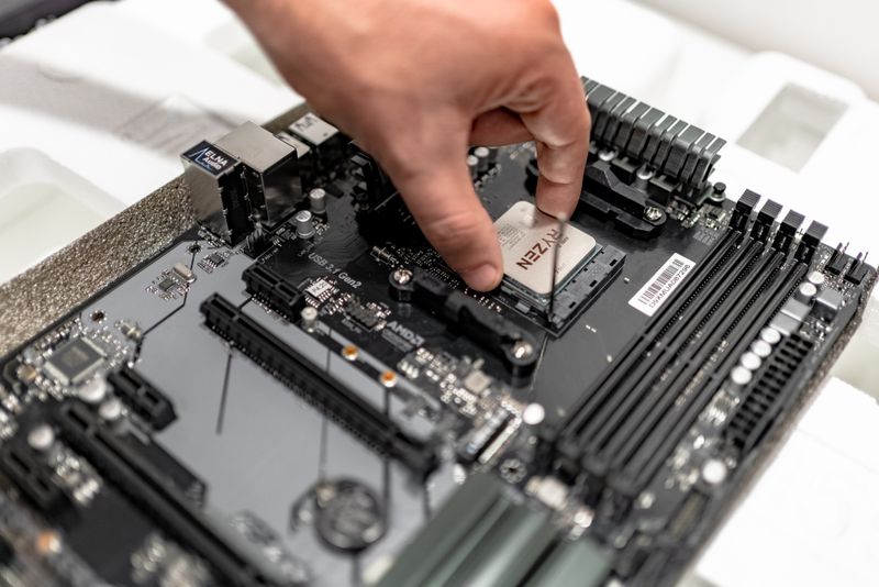 Hand installing a CPU processor on a motherboard