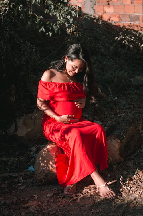 Free A Pregnant Woman Wearing a Red Dress Stock Photo