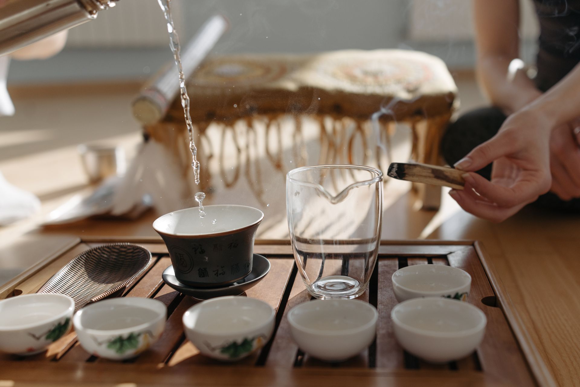 A Person Pouring Hot Water on a Teapot