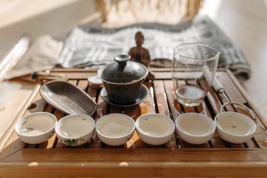 A serene display of a traditional tea ceremony set with teacups on a wooden tray, radiating cultural elegance.