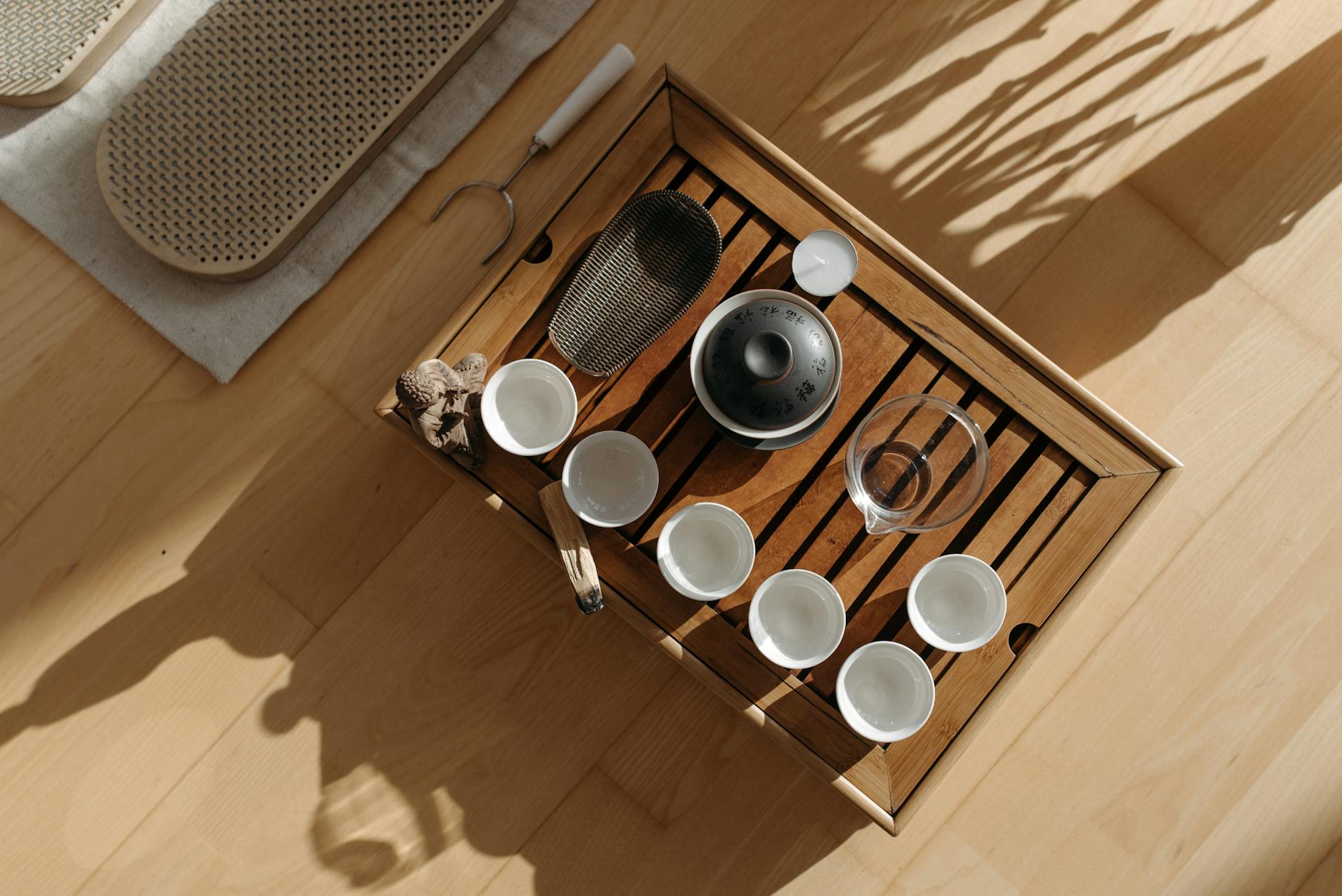 https://www.pexels.com/photo/high-angle-shot-white-ceramic-teacups-on-brown-wooden-table-7596854/
