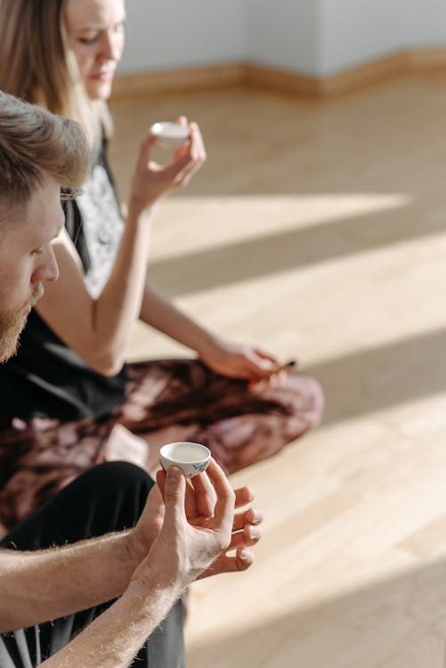 A Man and a Woman Holding a Teacup