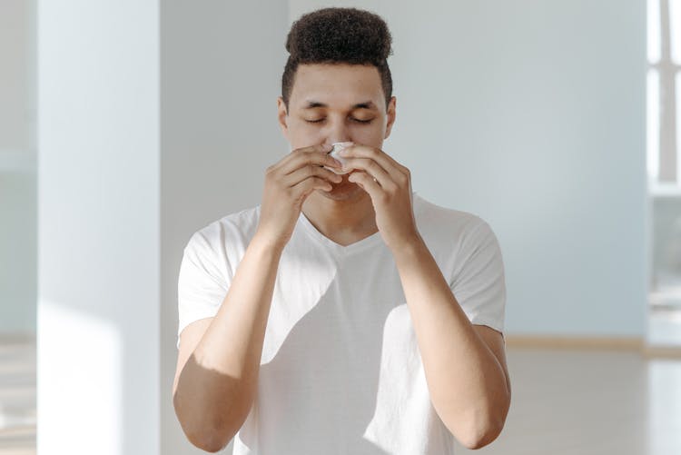 Sick Man In White Shirt Wiping His Nose With Tissue