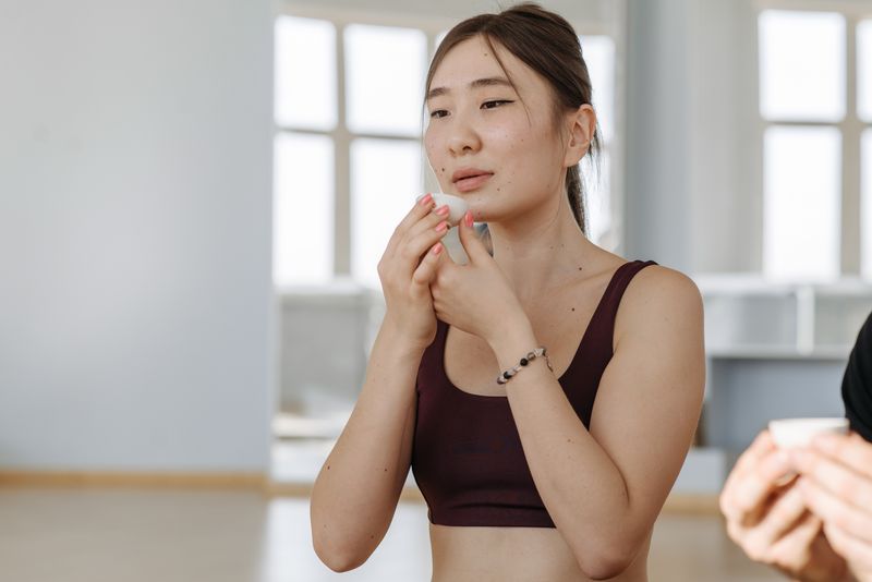 Woman in activewear drinking tea