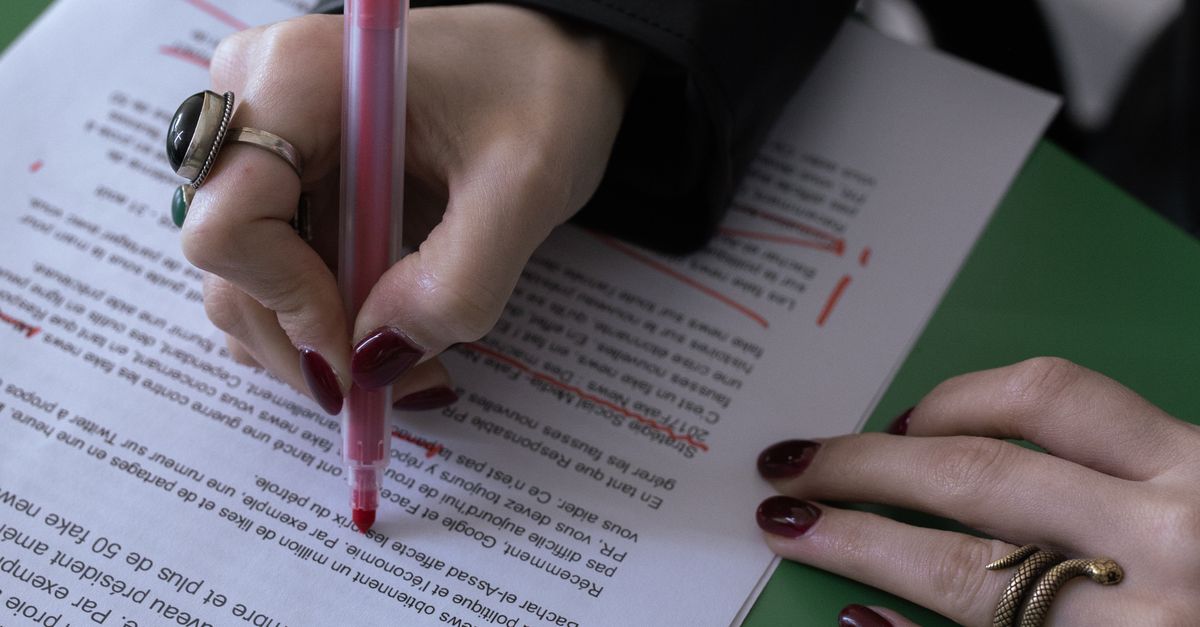Hand Some Mark Text A Hand Marking Some Words on a Document · Free Stock Photo