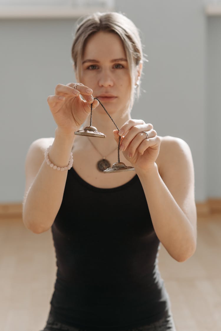 A Woman Holding Cymbals