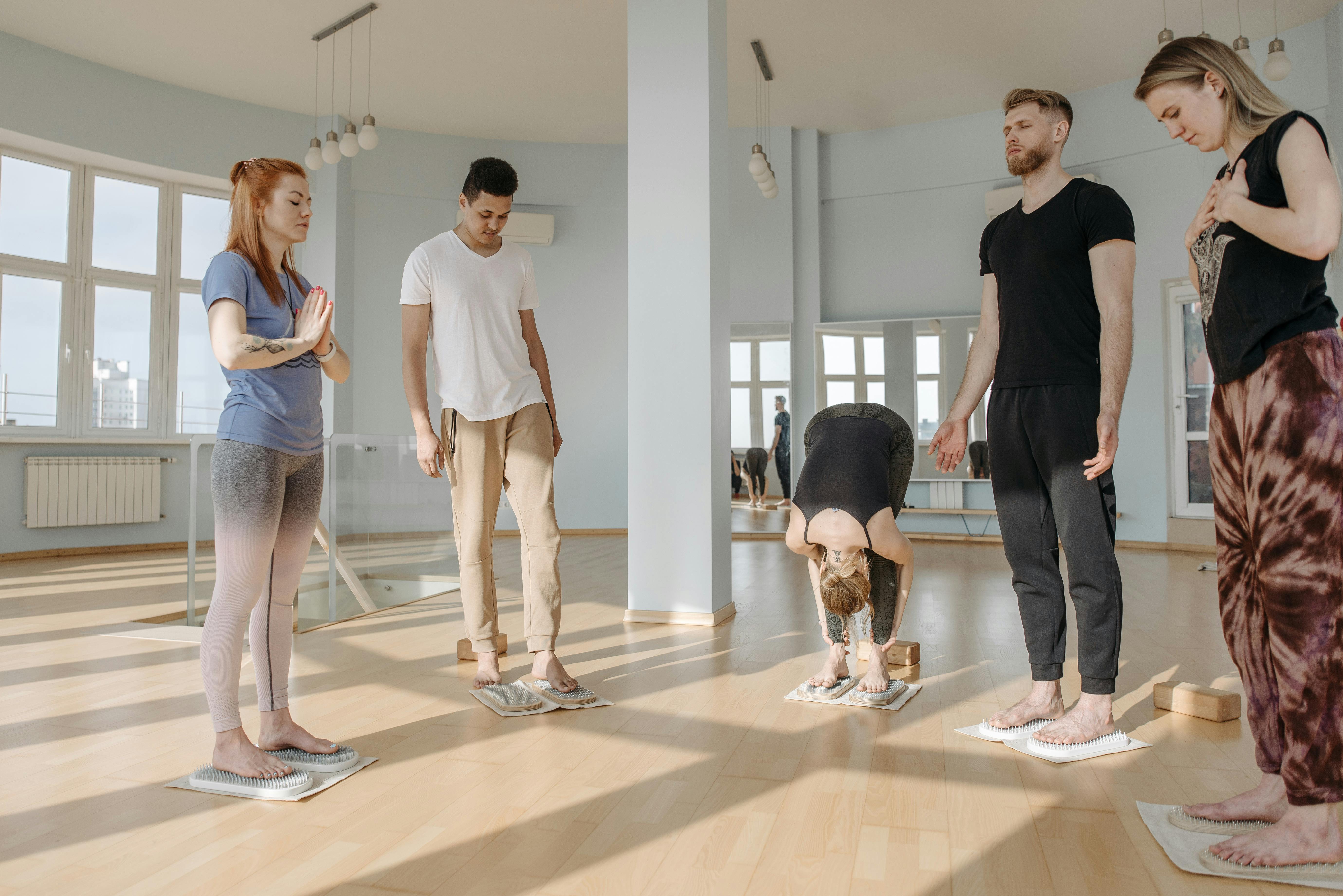 Participants in a yoga class practice meditation and relaxation on sadhu boards.