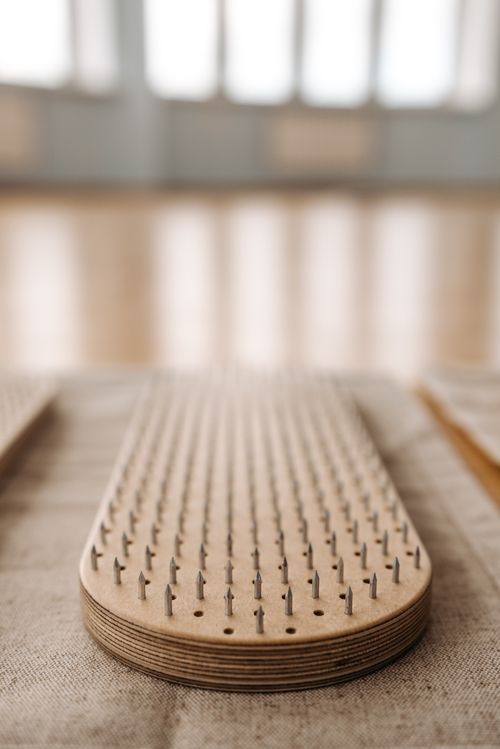 Free Close-up of a wooden sadhu board used for meditation and relaxation in a tranquil setting. Stock Photo