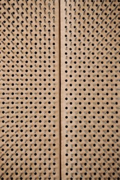 Detailed view of a wooden sadhu board with spikes, emphasizing texture and symmetry.
