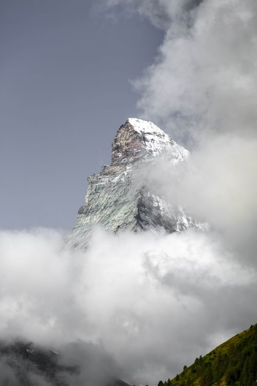 Free Discover the breathtaking Matterhorn peak piercing through dense clouds, a symbol of natural grandeur. Stock Photo