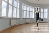 A Woman Doing a Yoga Pose While Standing on a Sadhu Board