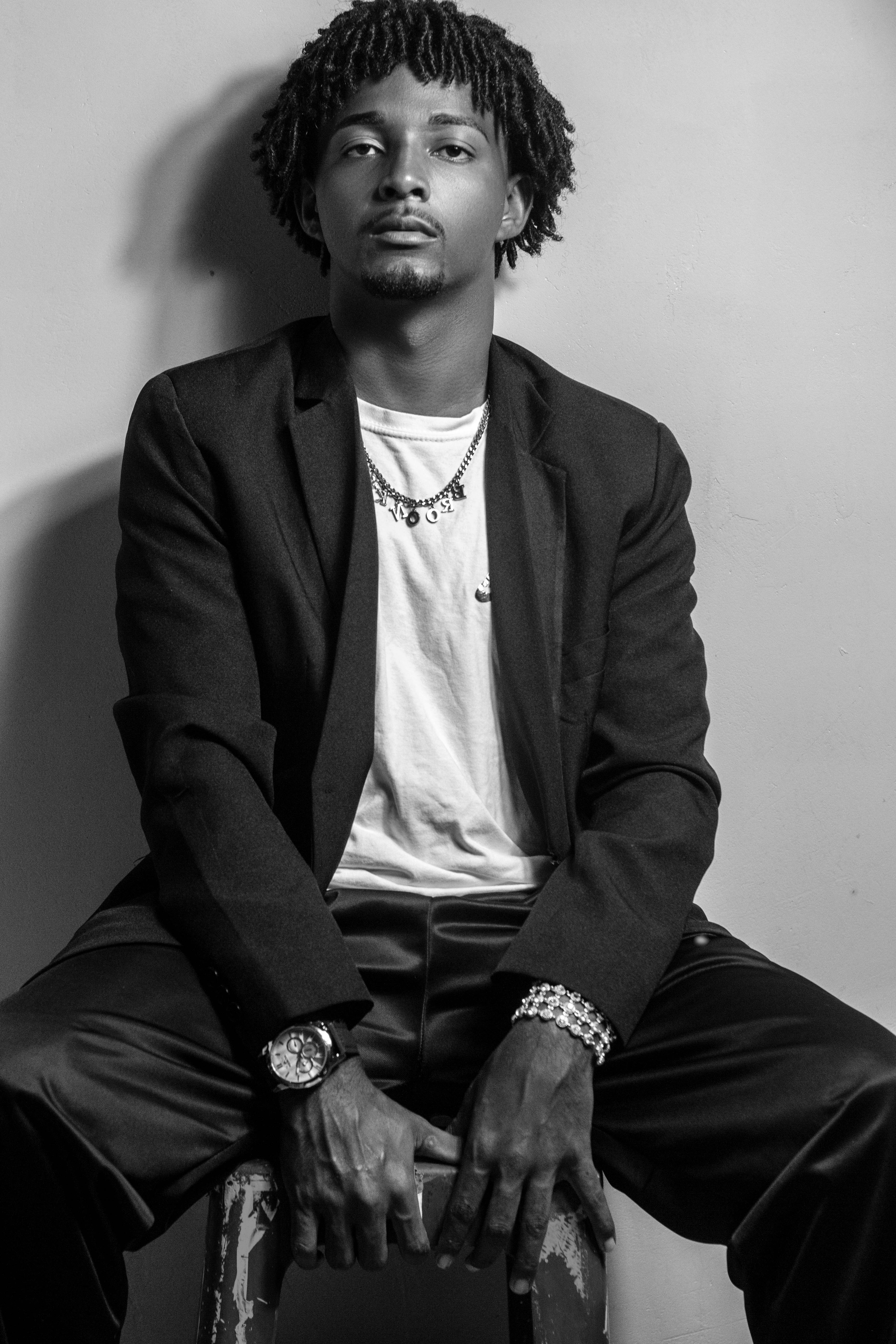 Monochrome portrait of a confident man in a suit with dreadlocks, São Paulo.