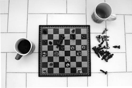 Mugs Beside a Chess Board 