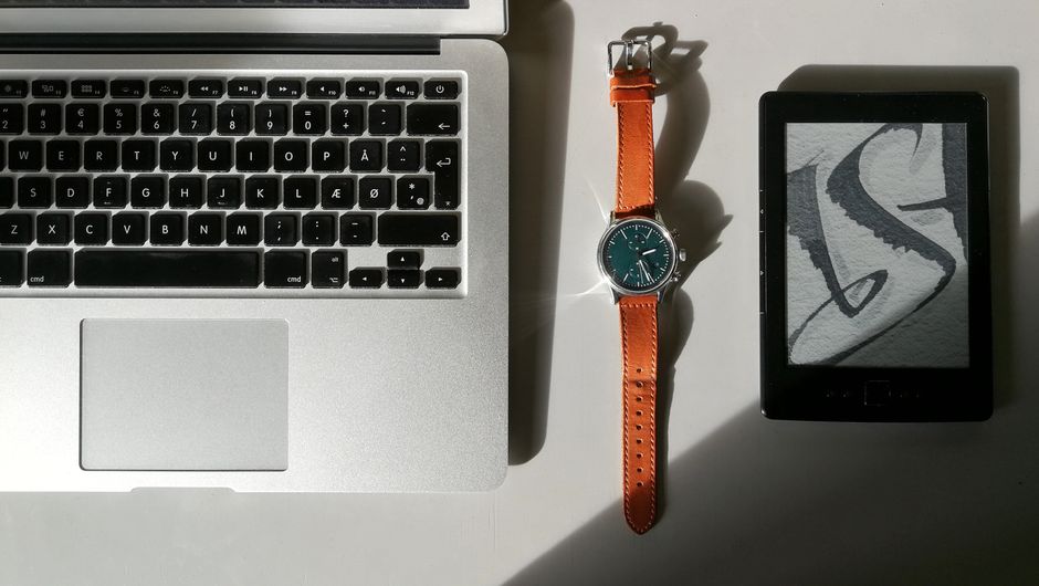 How Samsung Galaxy Watch Blood Pressure Monitoring Compares to Cuff Readings Flat lay of a laptop, wristwatch, and e-reader showcasing modern technology essentials.